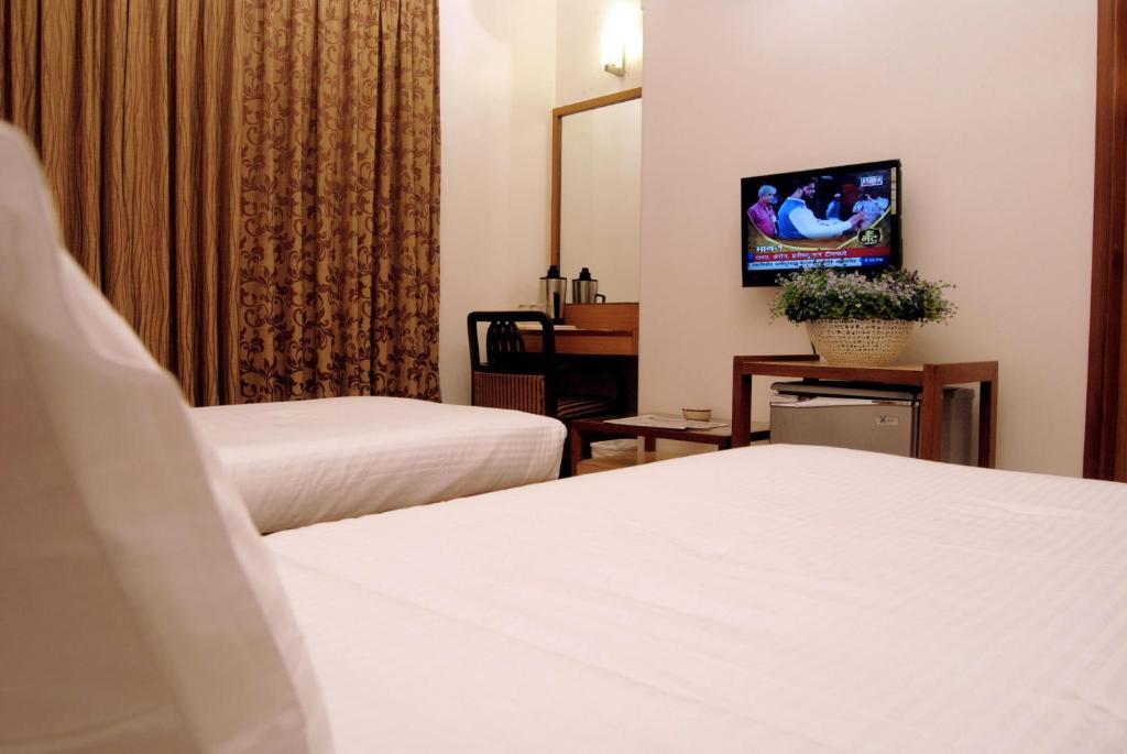 The Ambience Hotel Pune Quarto foto